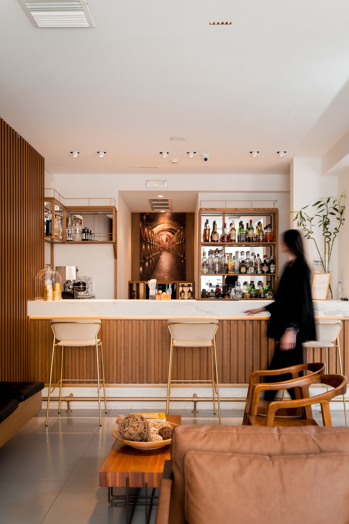 The hotel bar, with its marble counter and timber-slat wall