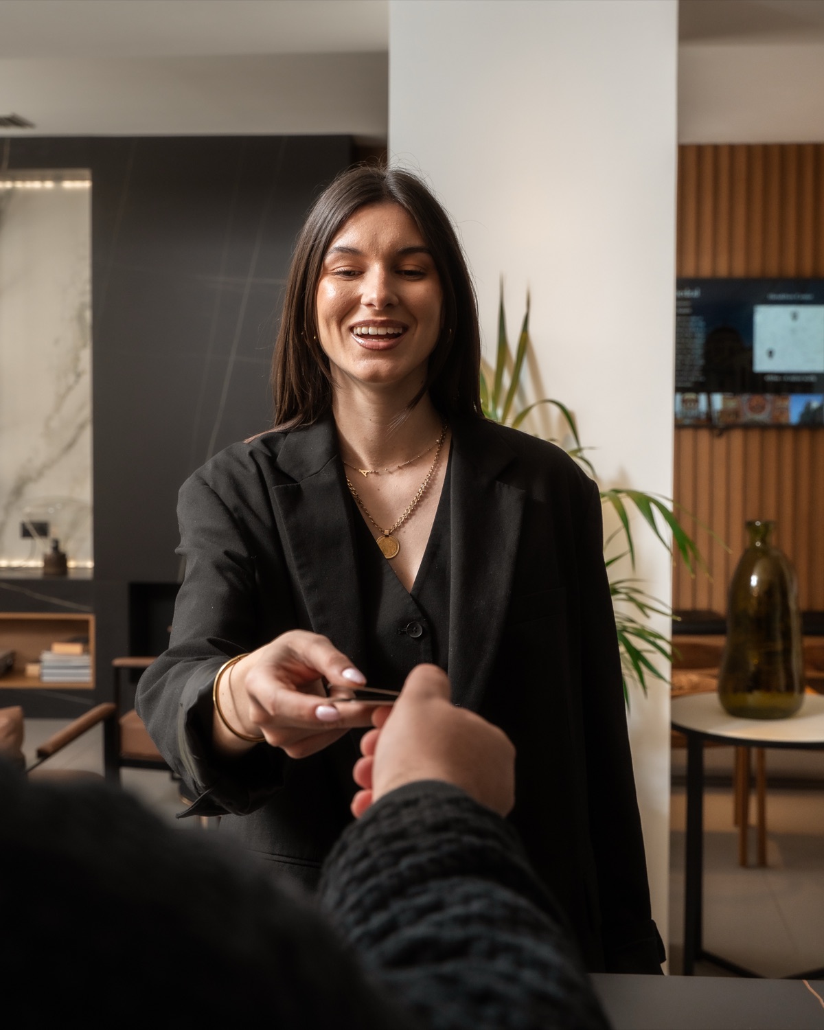 A member of staff helping a guest at reception